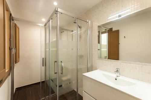 a bathroom with a glass shower and a sink at Lets Holidays apartment Sant Miquel in Tossa de Mar
