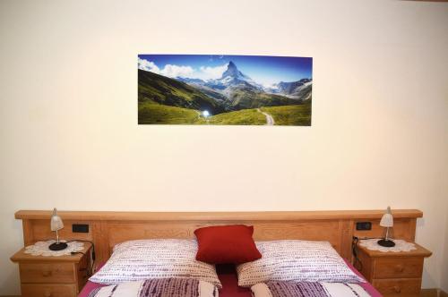 a bedroom with two beds and a picture on the wall at Ferienwohnung Leachwies in Schenna