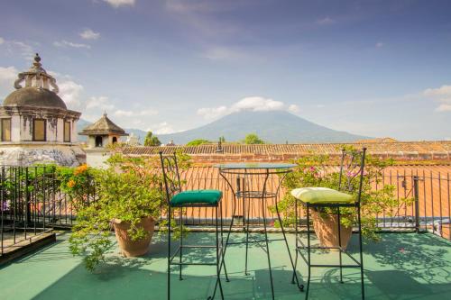 a patio with chairs and plants on a roof at Hotel Posada de Don Rodrigo Antigua in Antigua Guatemala