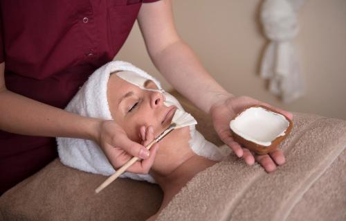 a woman getting a face massage with whipped cream at SALZANO Hotel - Spa - Restaurant in Interlaken