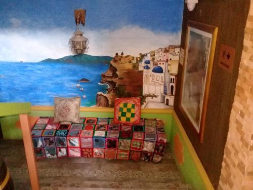 a bedroom with a bed with a painting on the wall at Hotel Atenas Jericó in Jericó