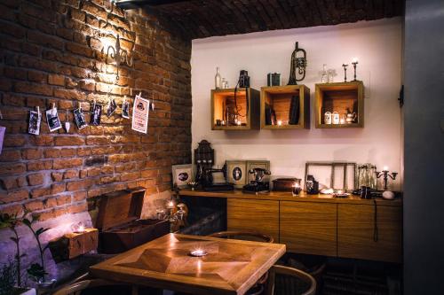 a dining room with a table and a brick wall at Penzion a relax centrum Andělka in Hanušovice