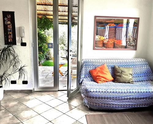 a blue couch sitting in front of a door at L'Antico Frantoio in Rapallo