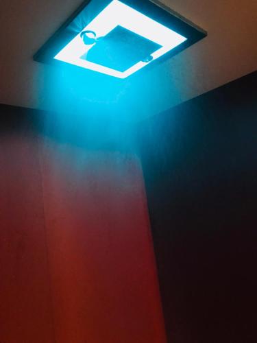 a light in a dark room with a red wall at Hotel Verdi in Vicenza