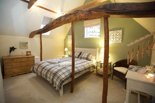 a bedroom with a canopy bed and a desk at Lut's Place in Lincoln