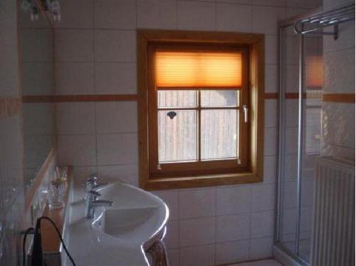 a bathroom with a sink and a window at Karnerhof in Mariapfarr
