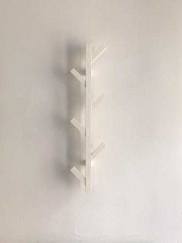a white shelf on a white wall at Madison Rooms in Sitges