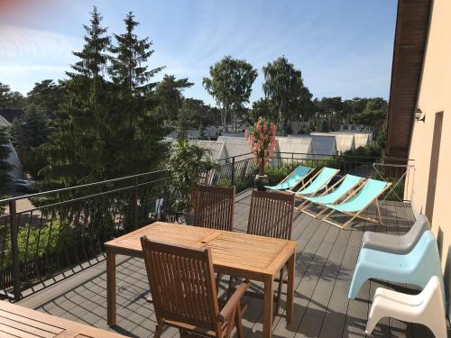 a patio with a table and chairs and a pool at Apartament Gratka in Dziwnówek
