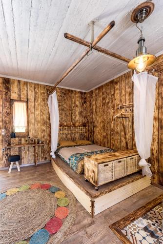 a bedroom with a bed in a room with wooden walls at Krassopsychia Apartments in Krásion