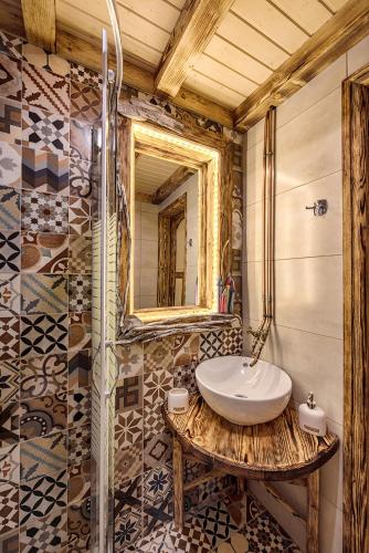 a bathroom with a sink and a mirror at Krassopsychia Apartments in Krásion
