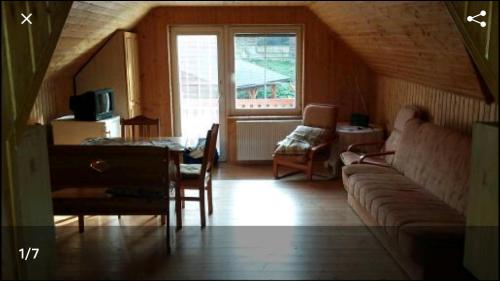 a living room with a couch and a table at Mansarda in Mýto pod Ďumbierom