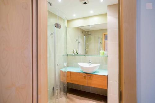 a bathroom with a sink and a mirror at Old Riga Modern Apartment in Riga
