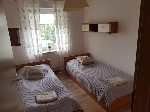 Un ou plusieurs lits dans un hébergement de l'établissement Apartament VIP Vęgoria