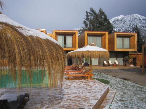 a resort with a bunch of tables and umbrellas at Cajón del Maipo Lodge in San José de Maipo