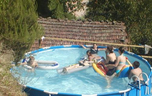 a group of people in a swimming pool at Villa Rosalena in Bagni di Lucca