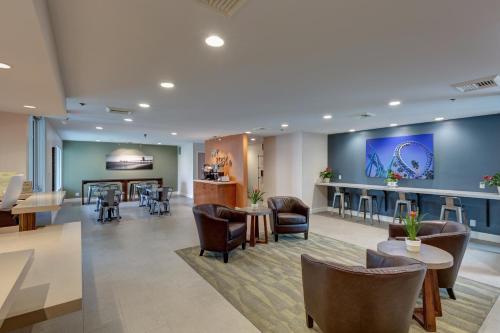 a lobby of a hospital with chairs and tables at Good Nite Inn Buena Park in Buena Park