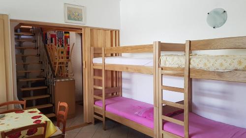 a room with two bunk beds and a table at Apartment Barbara in Novalja