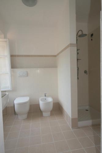 a bathroom with a toilet and a sink and a shower at Villa Rosalena in Bagni di Lucca