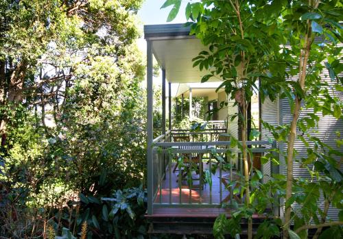 a screened in porch of a house with trees at Lilyponds Holiday Park in Mapleton