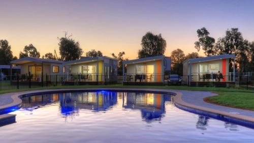 a house with a pool in front of it at Tasman Holiday Parks - Lake Mulwala in Mulwala