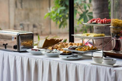 a table with a buffet of food on it at King Rock Residence in Siem Reap