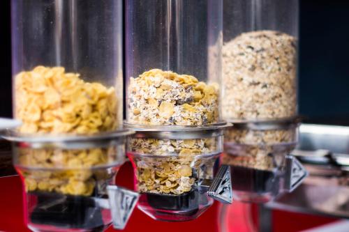 three plastic containers filled with different types of food at King Rock Residence in Siem Reap