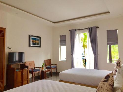 Ένα ή περισσότερα κρεβάτια σε δωμάτιο στο Yen villa Hội An