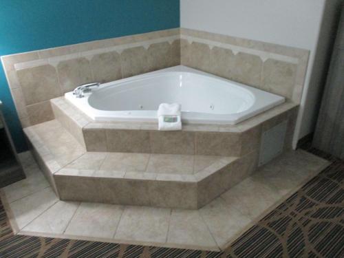uma banheira com uma toalha em cima em Best Western Presidential Hotel & Suites em Pine Bluff
