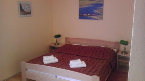 a bedroom with a bed with two towels on it at Grand Hotel in Třebíč