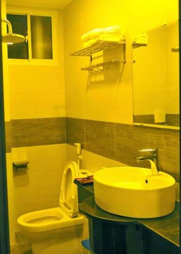 a bathroom with a sink and a toilet at Aries Hotel in Tuy Hoa
