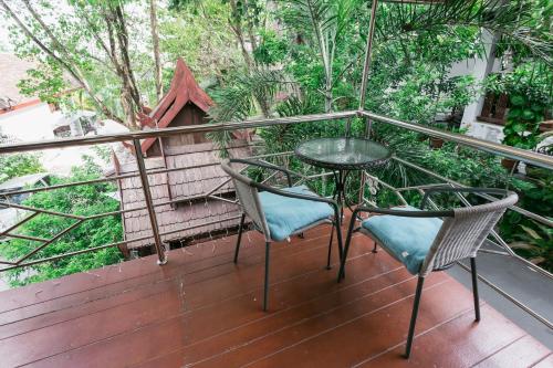 a balcony with a table and two chairs at Krabi Villa Phu Khao Private Resort in Klong Muang Beach