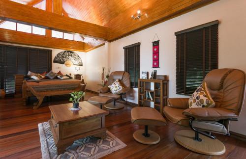 a living room with chairs and a couch at Krabi Villa Phu Khao Private Resort in Klong Muang Beach