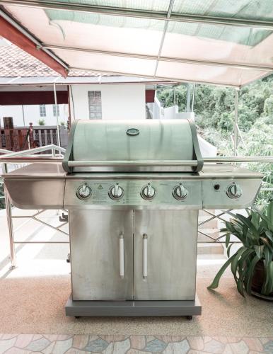 a green grill sitting on top of a patio at Krabi Villa Phu Khao Private Resort in Klong Muang Beach