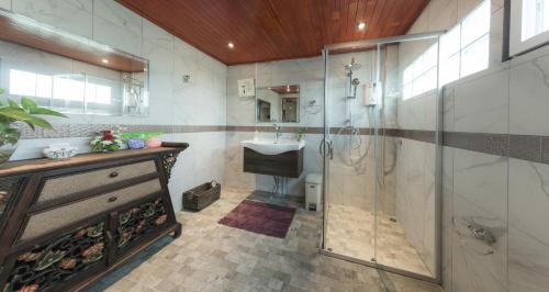 a bathroom with a shower and a sink at Krabi Villa Phu Khao Private Resort in Klong Muang Beach