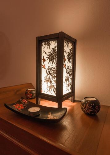 a wooden table with a plate and a window on it at Krabi Villa Phu Khao Private Resort in Klong Muang Beach