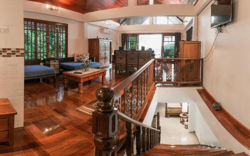 a living room with a staircase and a living room at Krabi Villa Phu Khao Private Resort in Klong Muang Beach