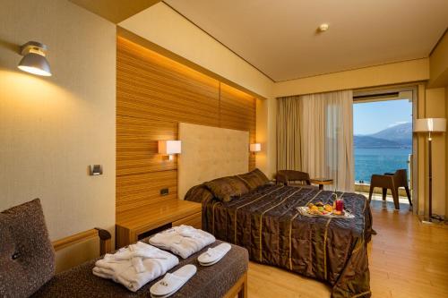 a hotel room with a bed and a view of the ocean at Nafs Hotel in Nafpaktos