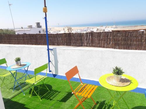 a patio with a table and chairs and a table at CH II Apartments ZONA DE OCIO NOCTURNO in Conil de la Frontera