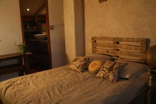 a bed with two pillows on it in a room at cool la source in Burdignes