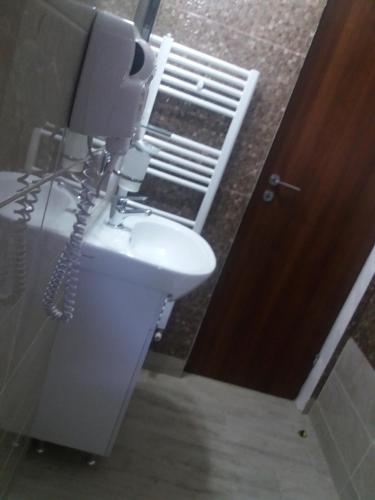 a phone in a bathroom next to a sink at Casa Lipianu in Târgu Jiu