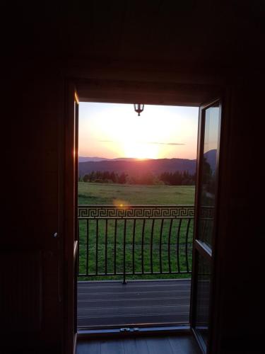 a door to a room with a view of the sunset at Gniewnik in Pcim