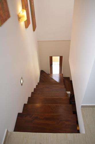 a staircase in a house with wooden floors and white walls at ESTIA V.M in Ýpsos