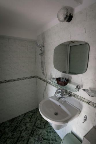 a bathroom with a sink and a mirror at Cherry Garden Apartments in Sveti Vlas