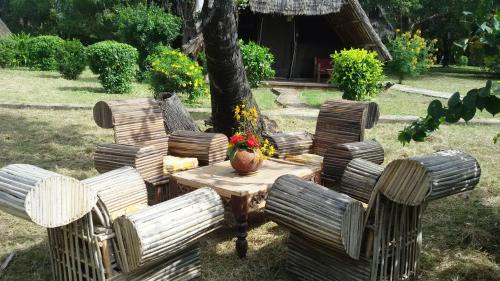 a group of chairs and a table in a yard at Bahari Pori Resort in Pangani