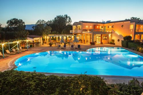 a large swimming pool in front of a house at Aeolian Gaea Hotel in Skala Kallonis