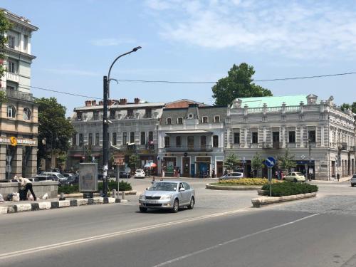 a car driving down a street in front of a building at Kope Palace in Tbilisi City