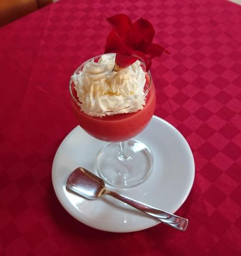 a dessert on a plate on a red table at Barbara B&B in Fontane Bianche