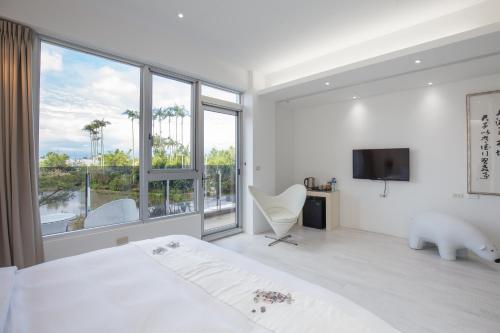a bedroom with a bed and a large window at WMS Villa in Dongshan