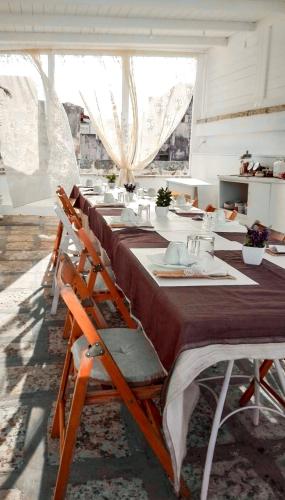 a long dining room with a long table at Il Borgo in Poggiardo