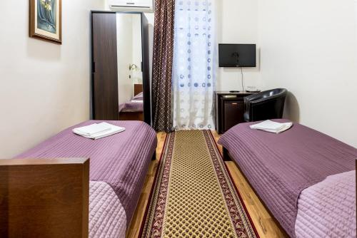 Tempat tidur dalam kamar di Hotel Corso